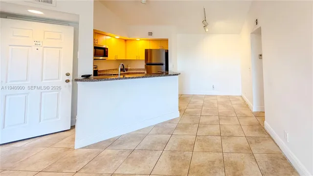 a kitchen with a stove and a refrigerator