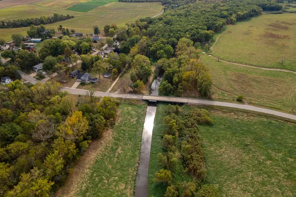 an aerial view of residential houses with outdoor space and river