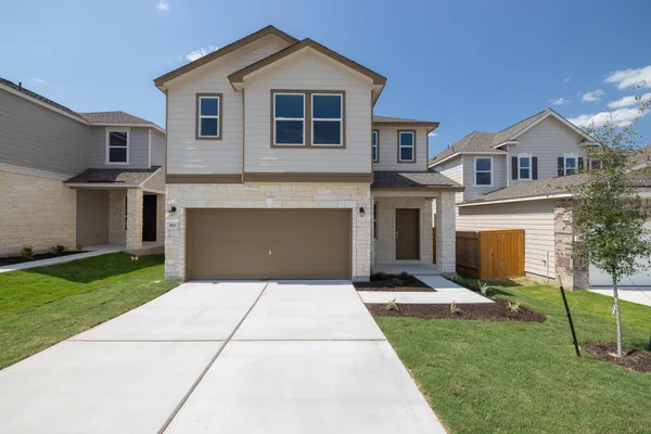 a front view of a house with a yard and outdoor seating