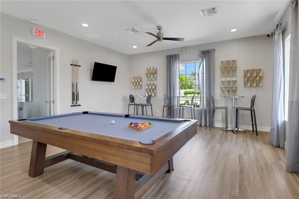 847 Enbrook Loop Naples, FL 34114 - Photo 15 of 17 a living room with furniture pool table wooden floor and a table