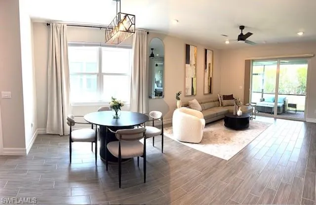 a living room with furniture wooden floor and a chandelier
