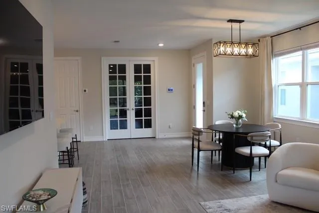 a view of a dining room with furniture and wooden floor
