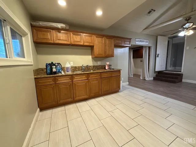 a kitchen with stainless steel appliances a sink stove and cabinets
