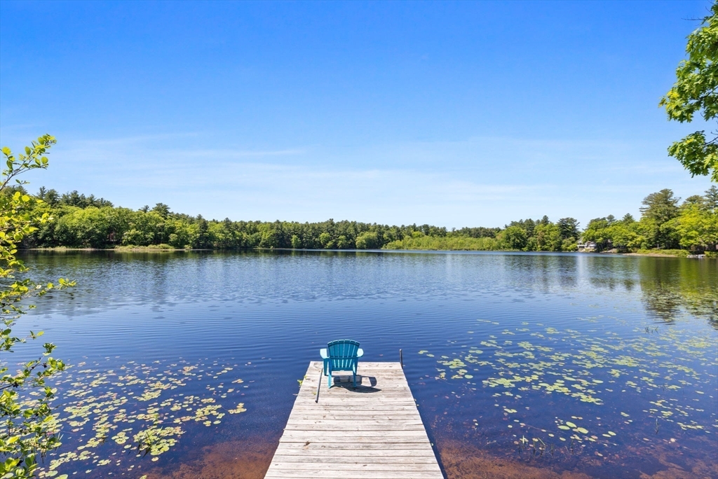35 Keyes Road Westford, MA 01886 - Photo 32 of 40 a view of a lake with a floor to ceiling window next to a yard