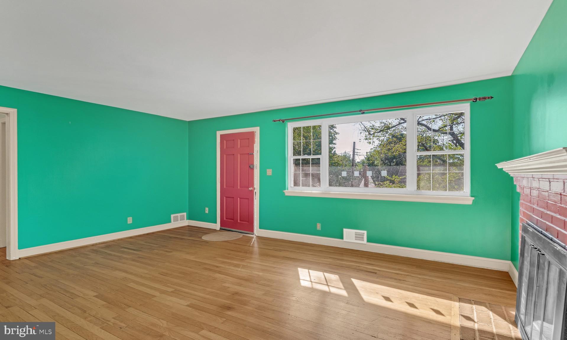 403 Belton Road Silver Spring, MD 20901 - Photo 3 of 22 a view of an empty room with a window and wooden floor