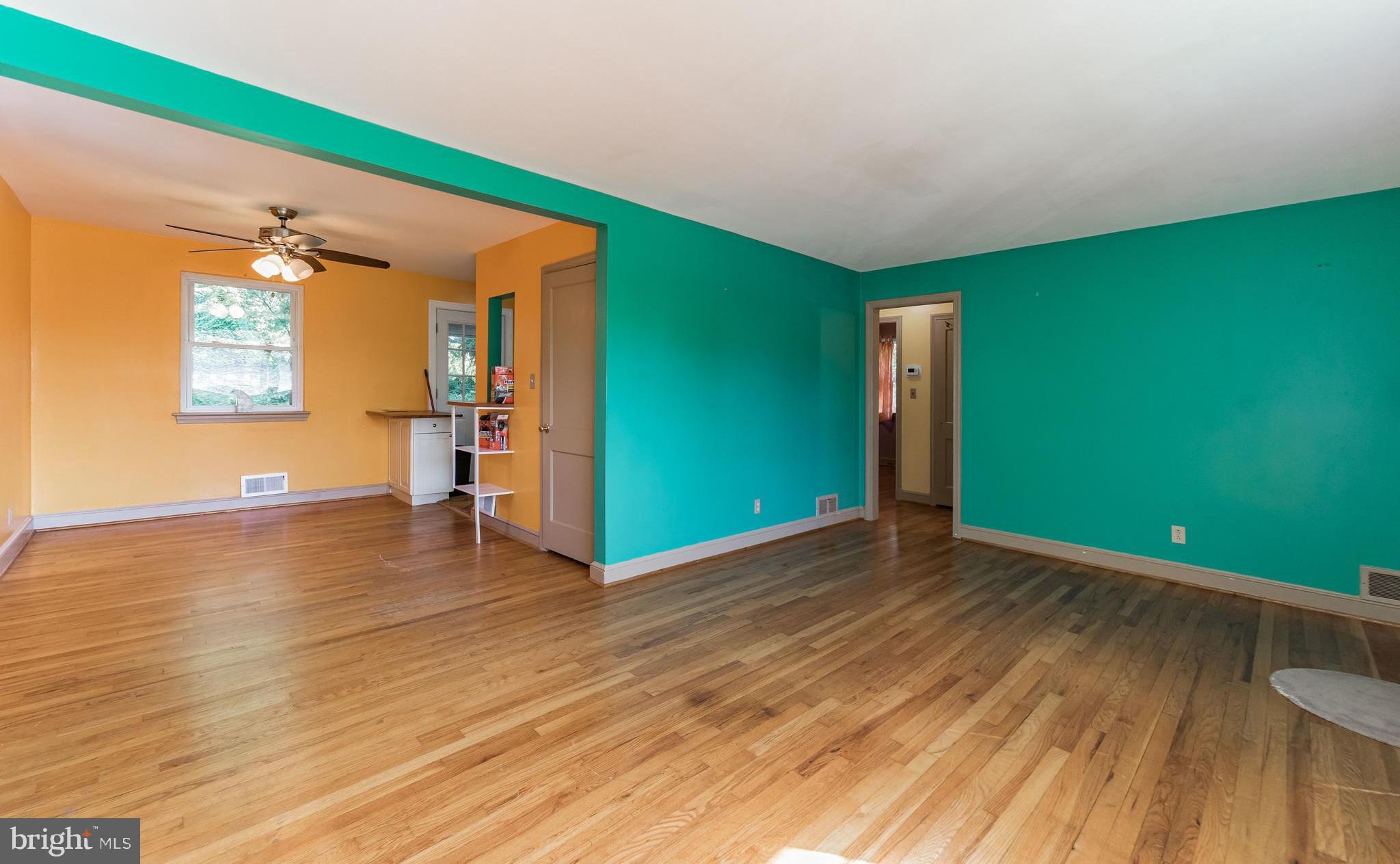 403 Belton Road Silver Spring, MD 20901 - Photo 5 of 22 a view of empty room with wooden floor and fan