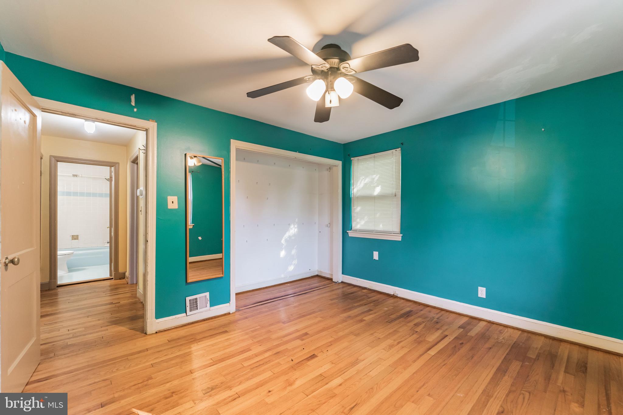 403 Belton Road Silver Spring, MD 20901 - Photo 9 of 22 a view of an empty room with window and wooden floor