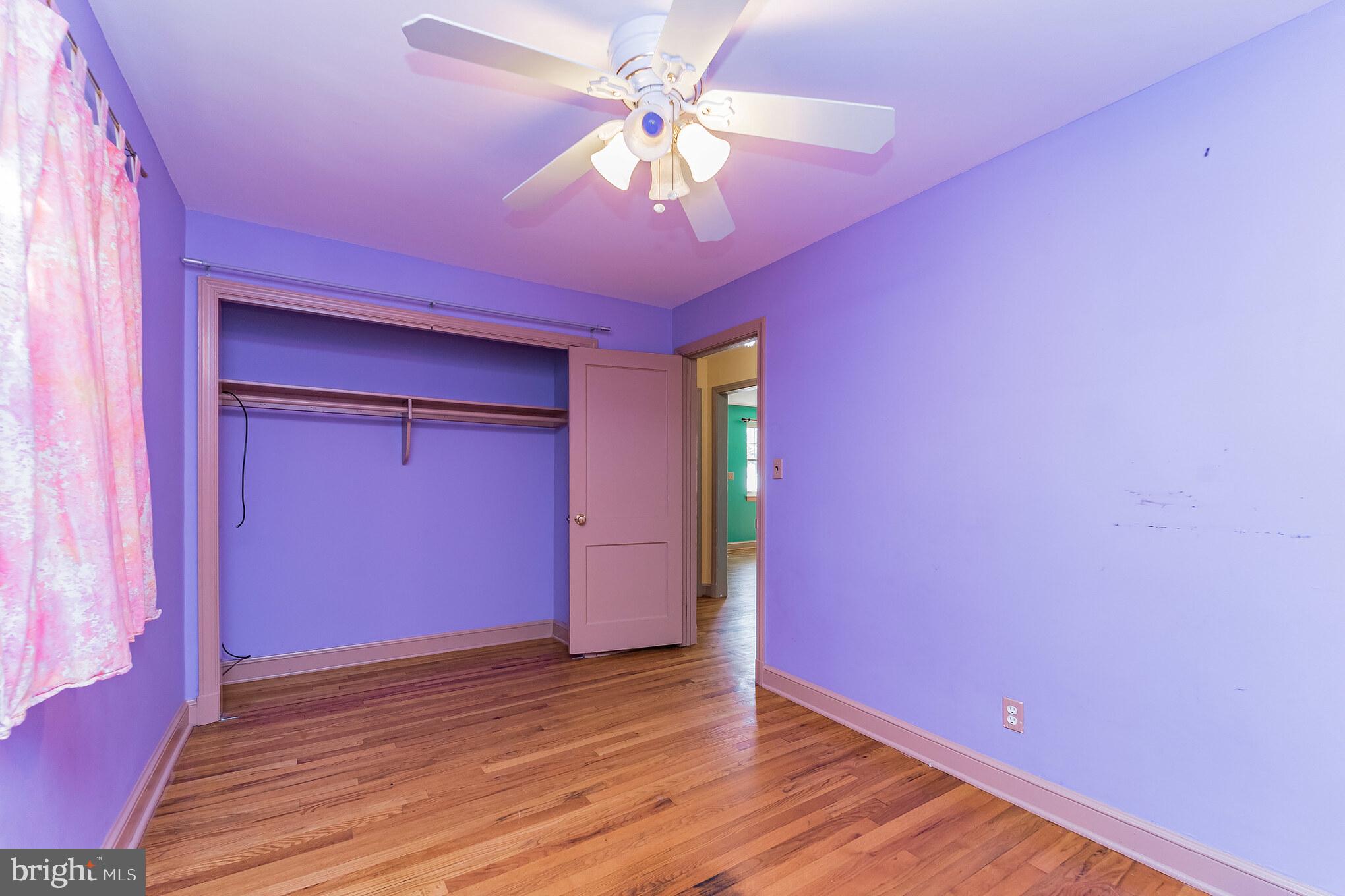 403 Belton Road Silver Spring, MD 20901 - Photo 10 of 22 a view of a room with wooden floor and a ceiling fan
