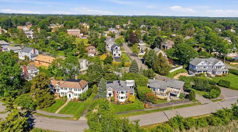 an aerial view of a house with a swimming pool yard and outdoor seating