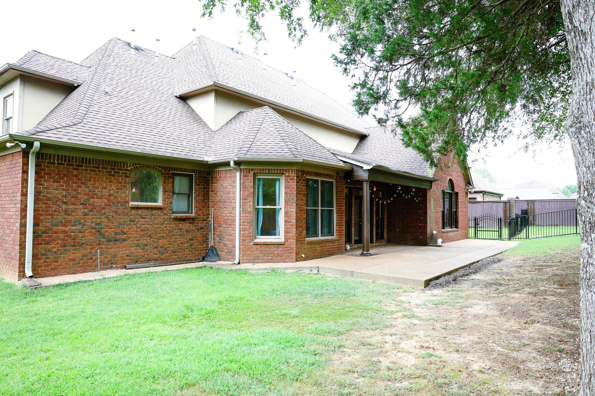 649 Ridge Springs Road Collierville, TN 38017 - Photo 5 of 35 Back of property with a patio, a shingled roof, and brick siding