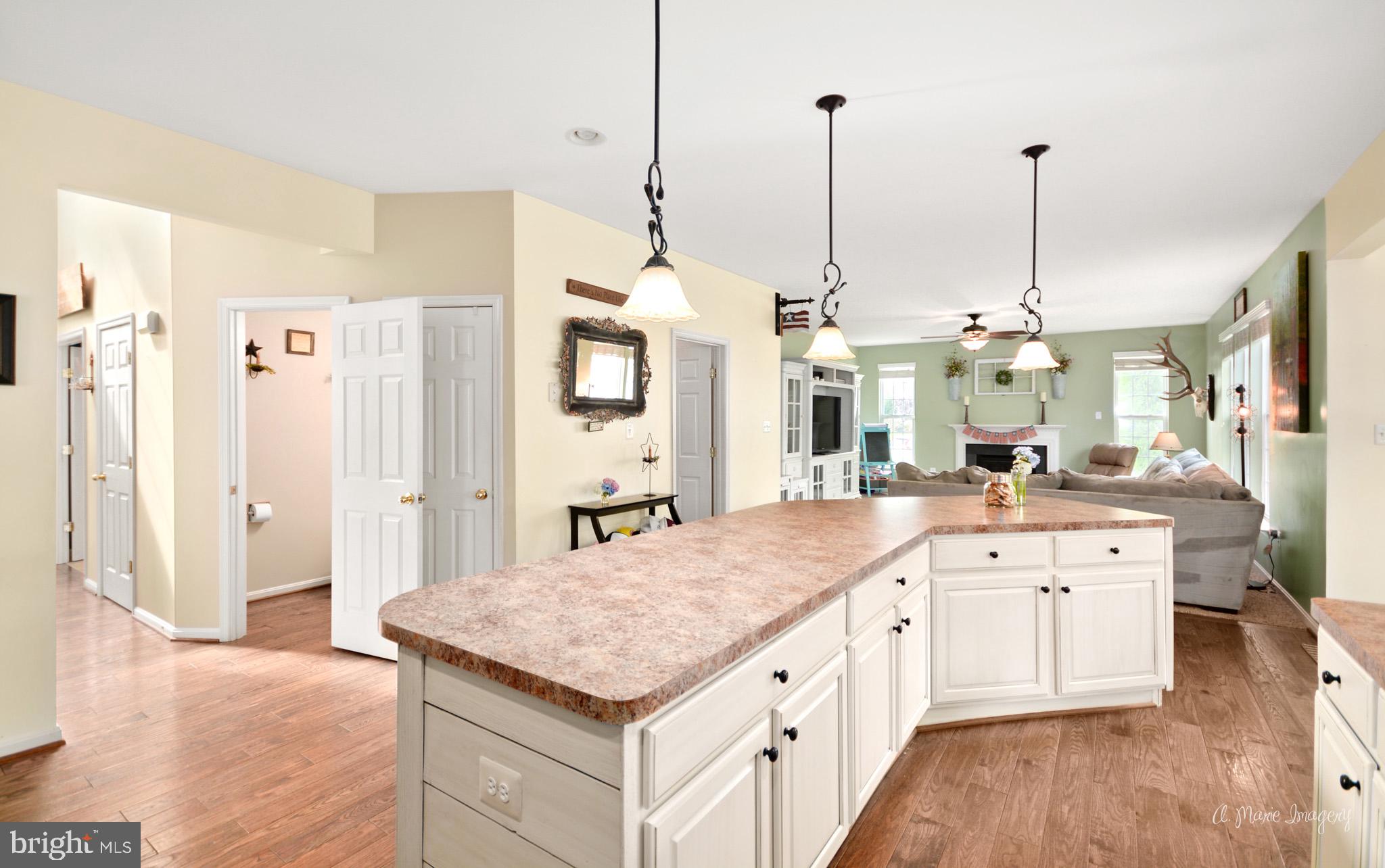 3904 Calico Circle Point of Rocks, MD 21777 - Photo 11 of 52 a large kitchen with kitchen island a sink stainless steel appliances and wooden floor