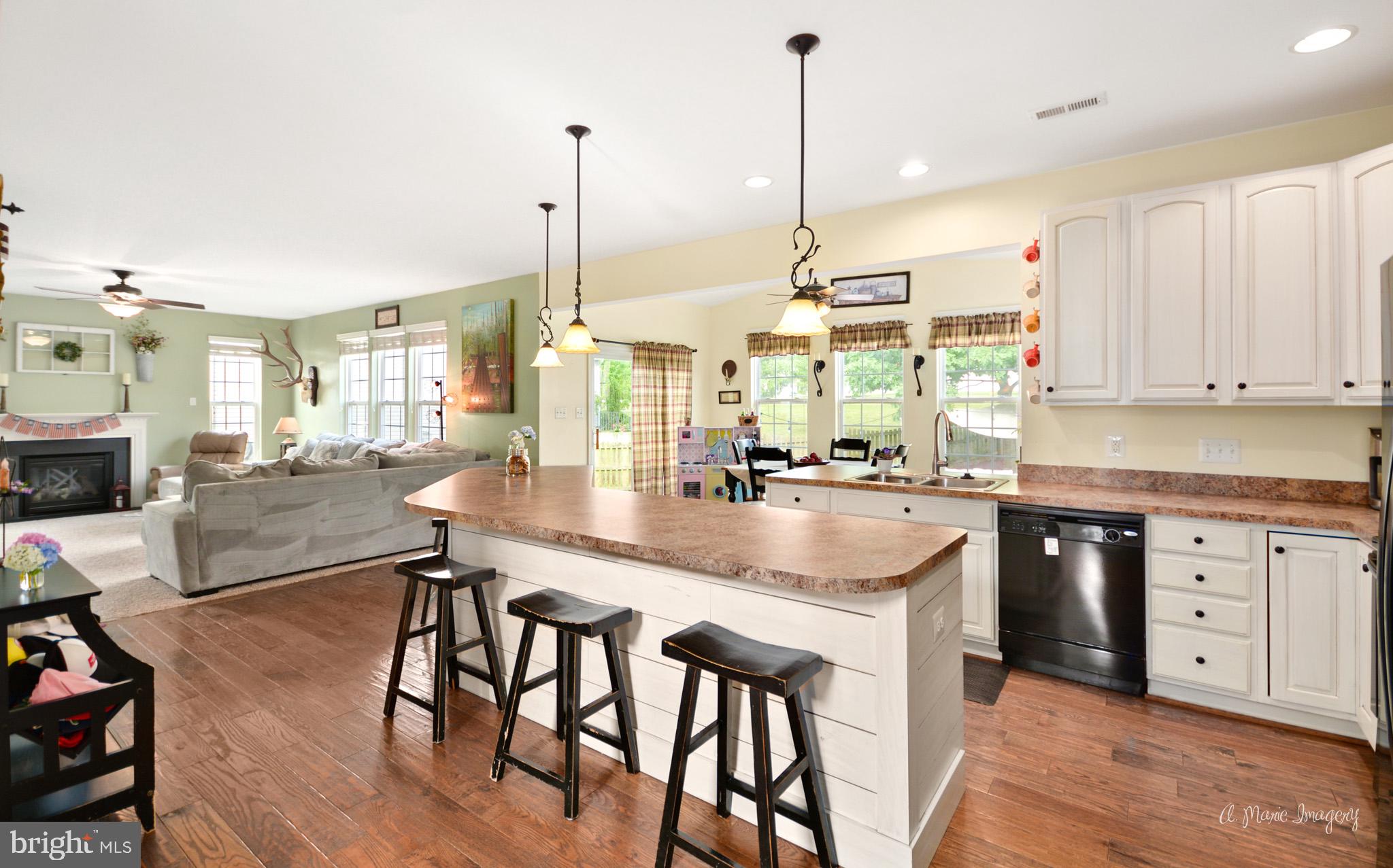 3904 Calico Circle Point of Rocks, MD 21777 - Photo 12 of 52 a kitchen with stainless steel appliances granite countertop table chairs sink and cabinets