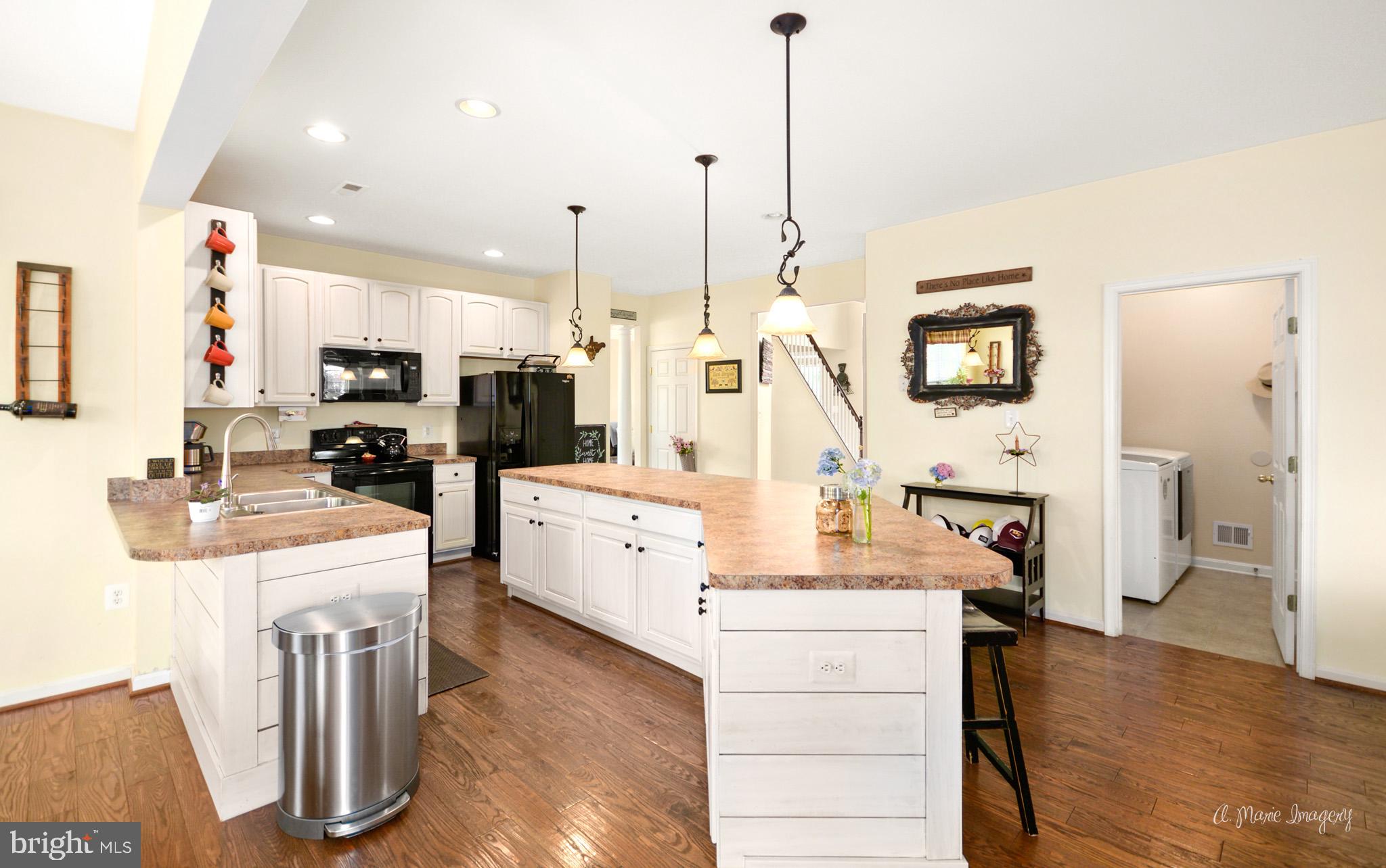 3904 Calico Circle Point of Rocks, MD 21777 - Photo 16 of 52 a kitchen with stainless steel appliances kitchen island granite countertop a stove a sink and a refrigerator