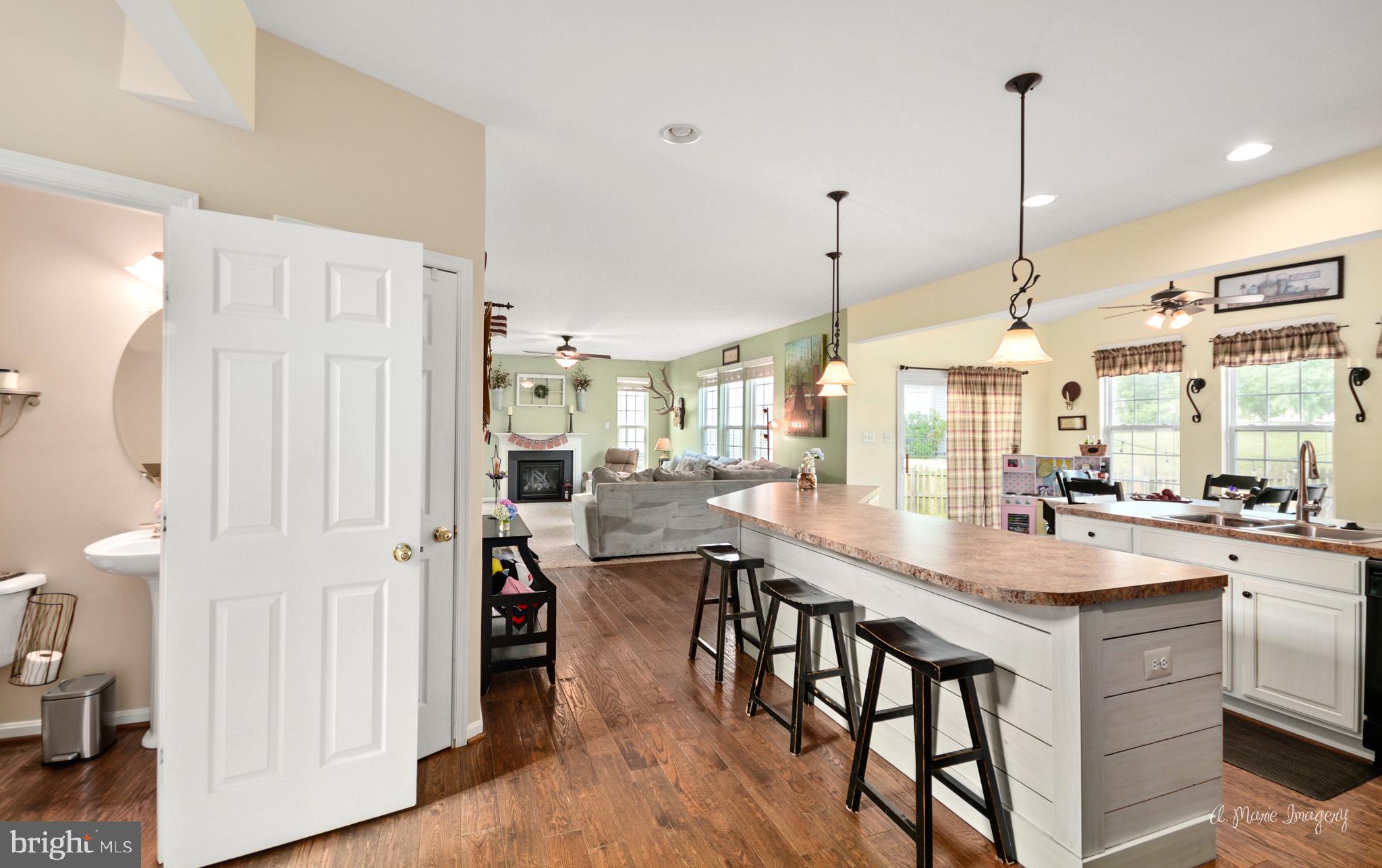 3904 Calico Circle Point of Rocks, MD 21777 - Photo 10 of 52 a kitchen with stainless steel appliances kitchen island granite countertop a table chairs and a wooden floor