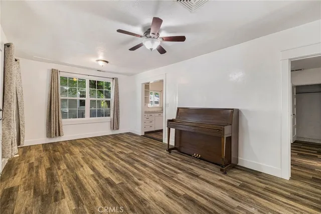 a large white kitchen with granite top and a large window