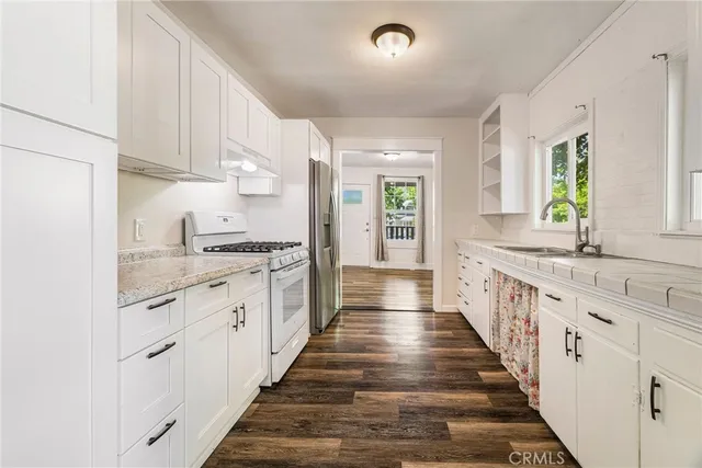 a bathroom with a granite countertop shower and a sink