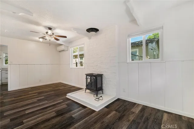 an aerial view of residential house with outdoor space and trees all around