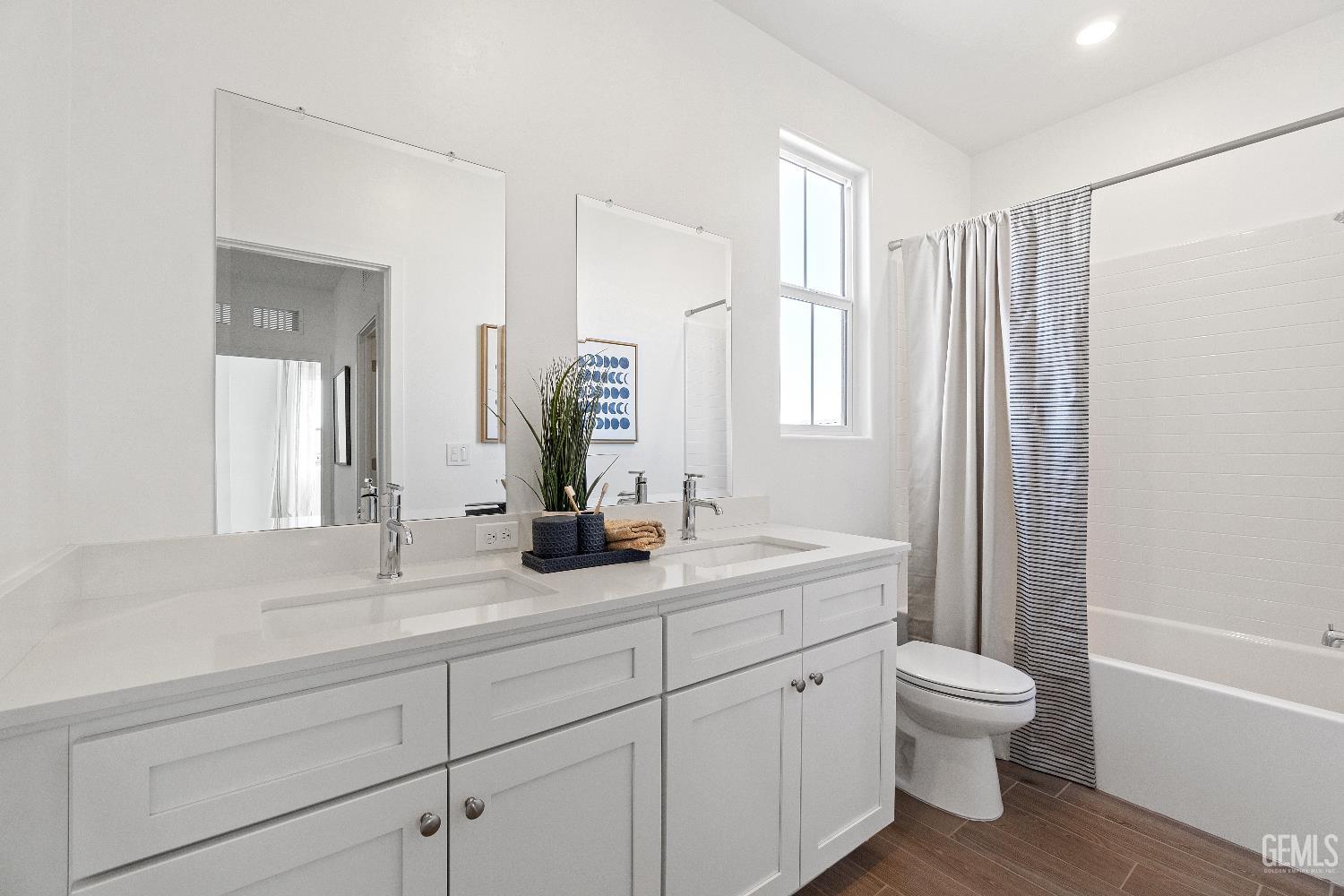 Undisclosed Address Shafter, CA 93263 - Photo 18 of 21 a bathroom with a granite countertop sink toilet a large mirror a bathtub and next to a window
