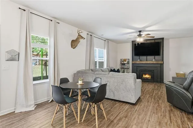a living room with furniture a flat screen tv and a fireplace