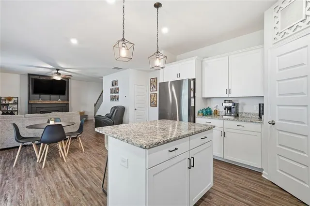 a living room with furniture and kitchen view