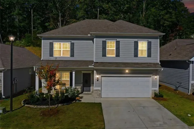 a front view of a house with a yard and garage