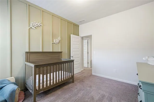 a bedroom with a bed and a potted plant
