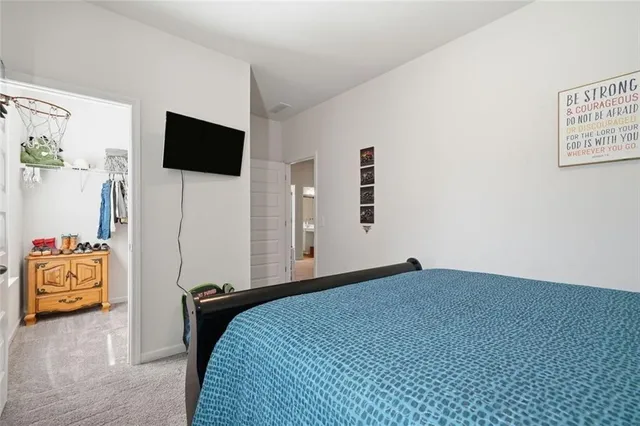 an aerial view of a house with swimming pool and large trees