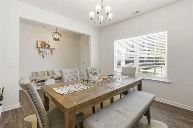 a view of a hallway with wooden floor and furniture