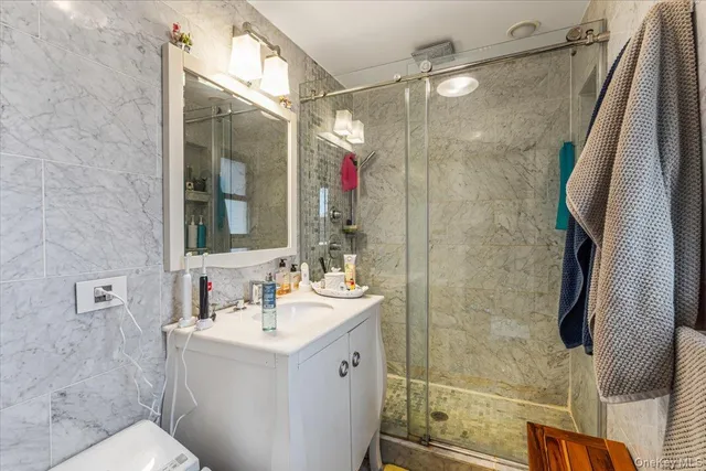 a bathroom with a sink mirror and shower