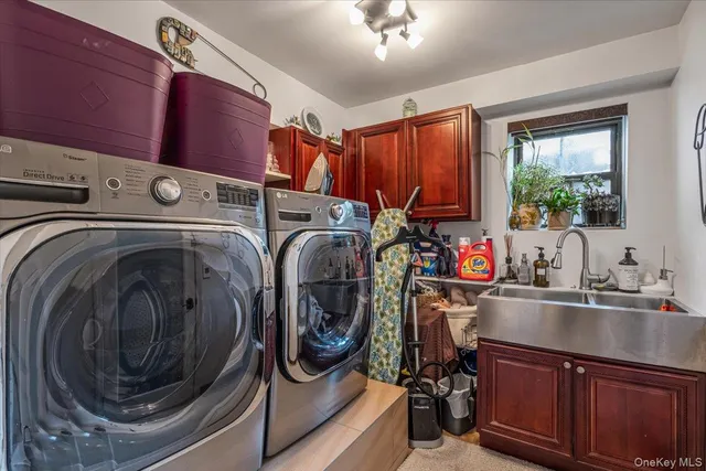 a utility room with sink dryer and washer