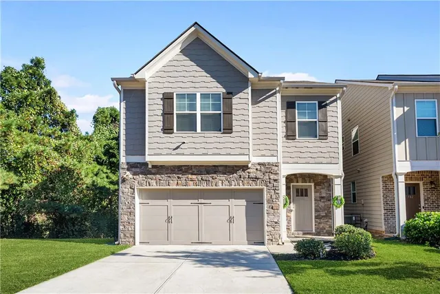 a front view of a house with a yard
