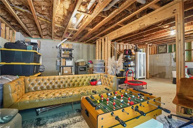 a view of a patio with couches chairs and a wooden floor