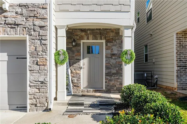 a front view of a house with plants