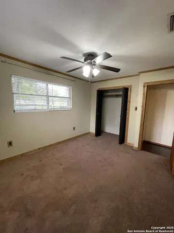 a view of a livingroom with a ceiling fan and window
