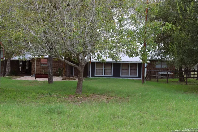 a view of a house with a backyard
