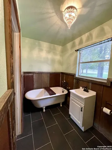 a bathroom with a sink a toilet and a window