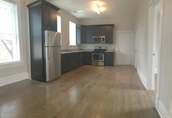 a kitchen with stainless steel appliances a refrigerator and a sink