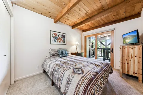 a bed sitting in a bedroom next to a window