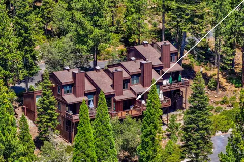 an aerial view of a house with garden space and street view
