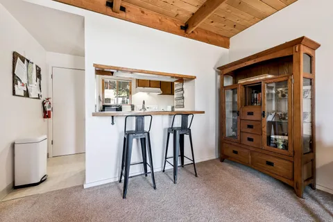 a view of an empty room with window and furniture