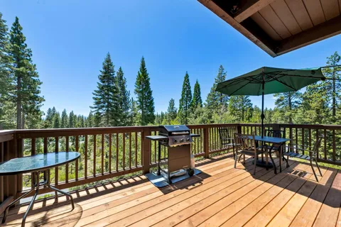 a view of a balcony with chairs and wooden floor