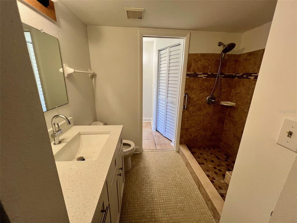 387 South McMullen Booth Road, Unit 13 Clearwater, FL 33759 - Photo 14 of 30 a bathroom with a tub a sink and a shower
