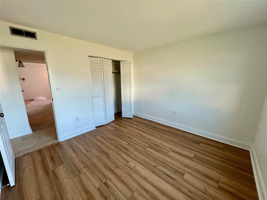 387 South McMullen Booth Road, Unit 13 Clearwater, FL 33759 - Photo 27 of 30 a view of empty room with wooden floor