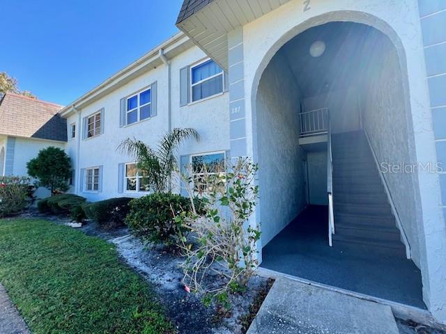 387 South McMullen Booth Road, Unit 13 Clearwater, FL 33759 - Photo 3 of 30 a front view of a house with a yard