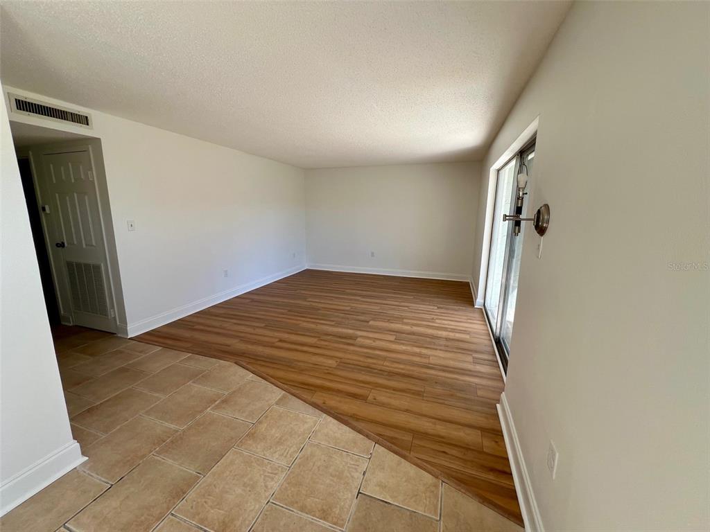 387 South McMullen Booth Road, Unit 13 Clearwater, FL 33759 - Photo 5 of 30 an empty room with a mirror