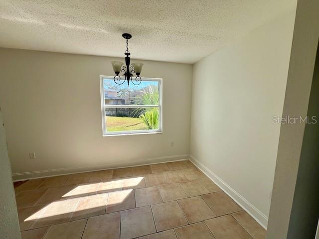 387 South McMullen Booth Road, Unit 13 Clearwater, FL 33759 - Photo 9 of 30 a room with window and a chandelier