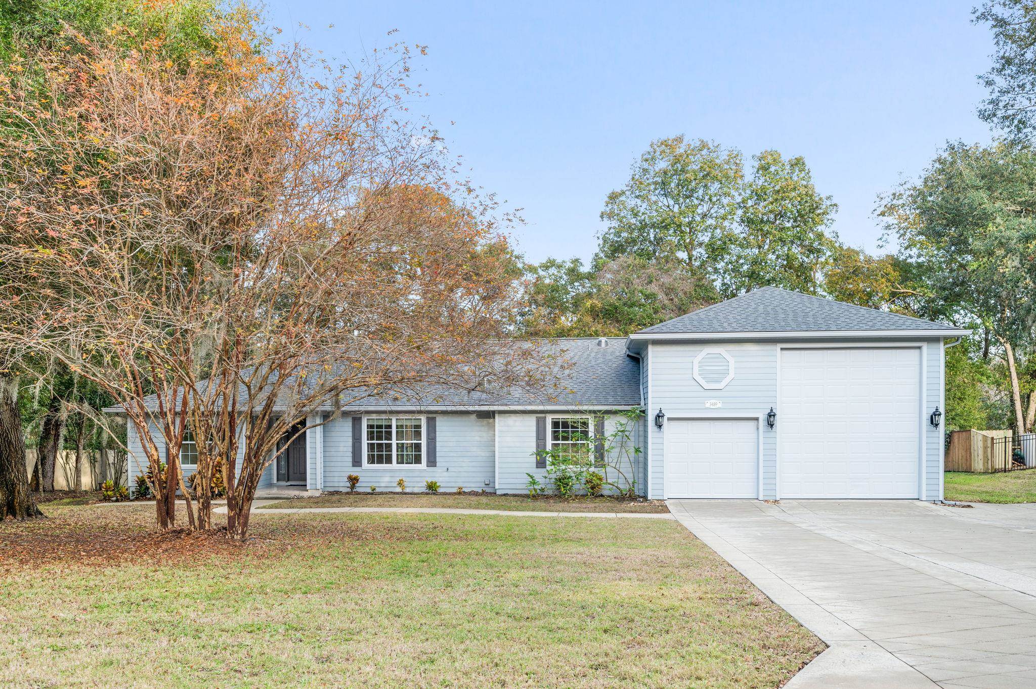 3489 Kings Road St. Augustine, FL 32086 - Photo 1 of 76 a front view of a house with a yard and garage