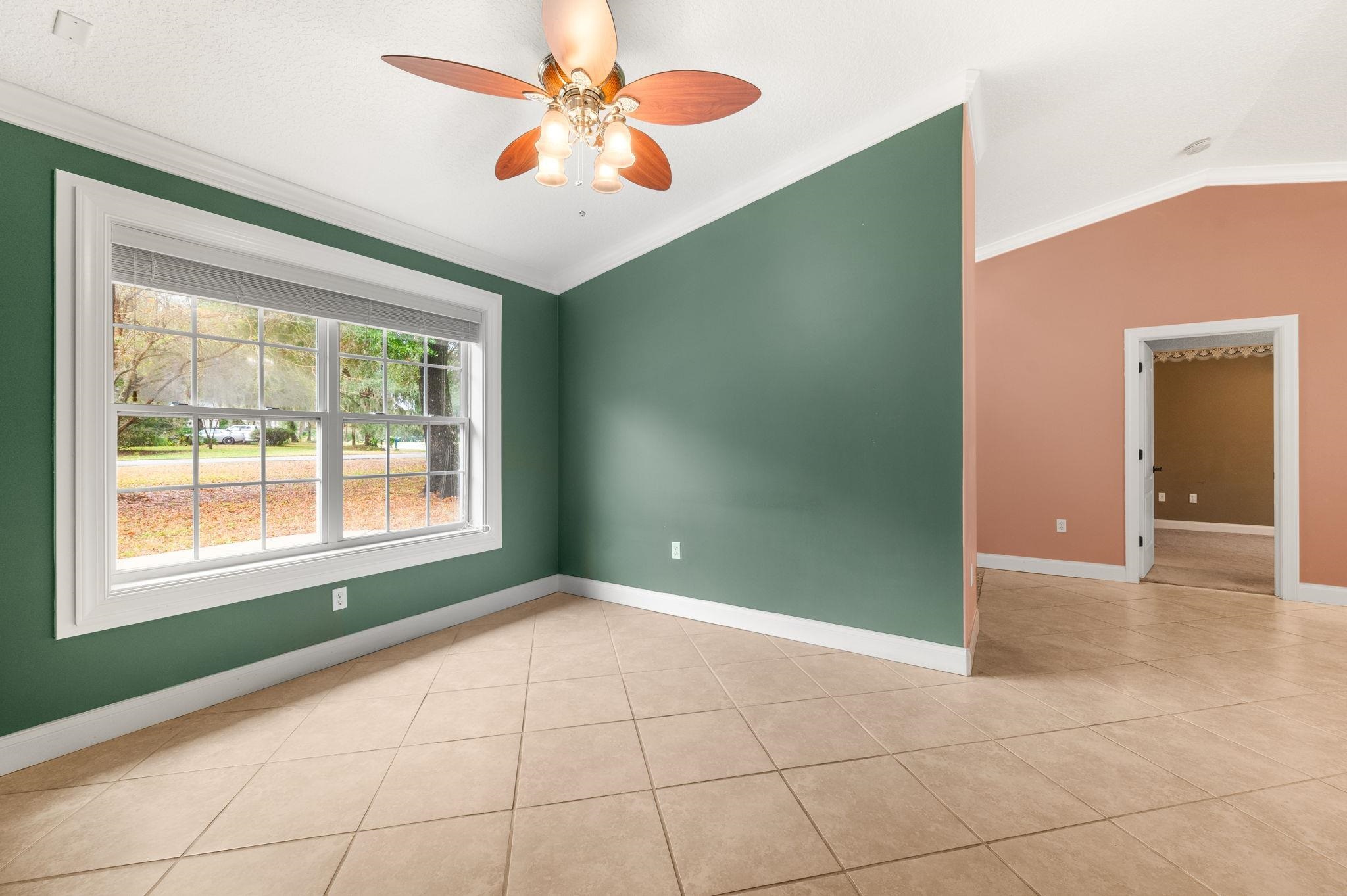 3489 Kings Road St. Augustine, FL 32086 - Photo 13 of 76 a view of an empty room with window and chandelier fan