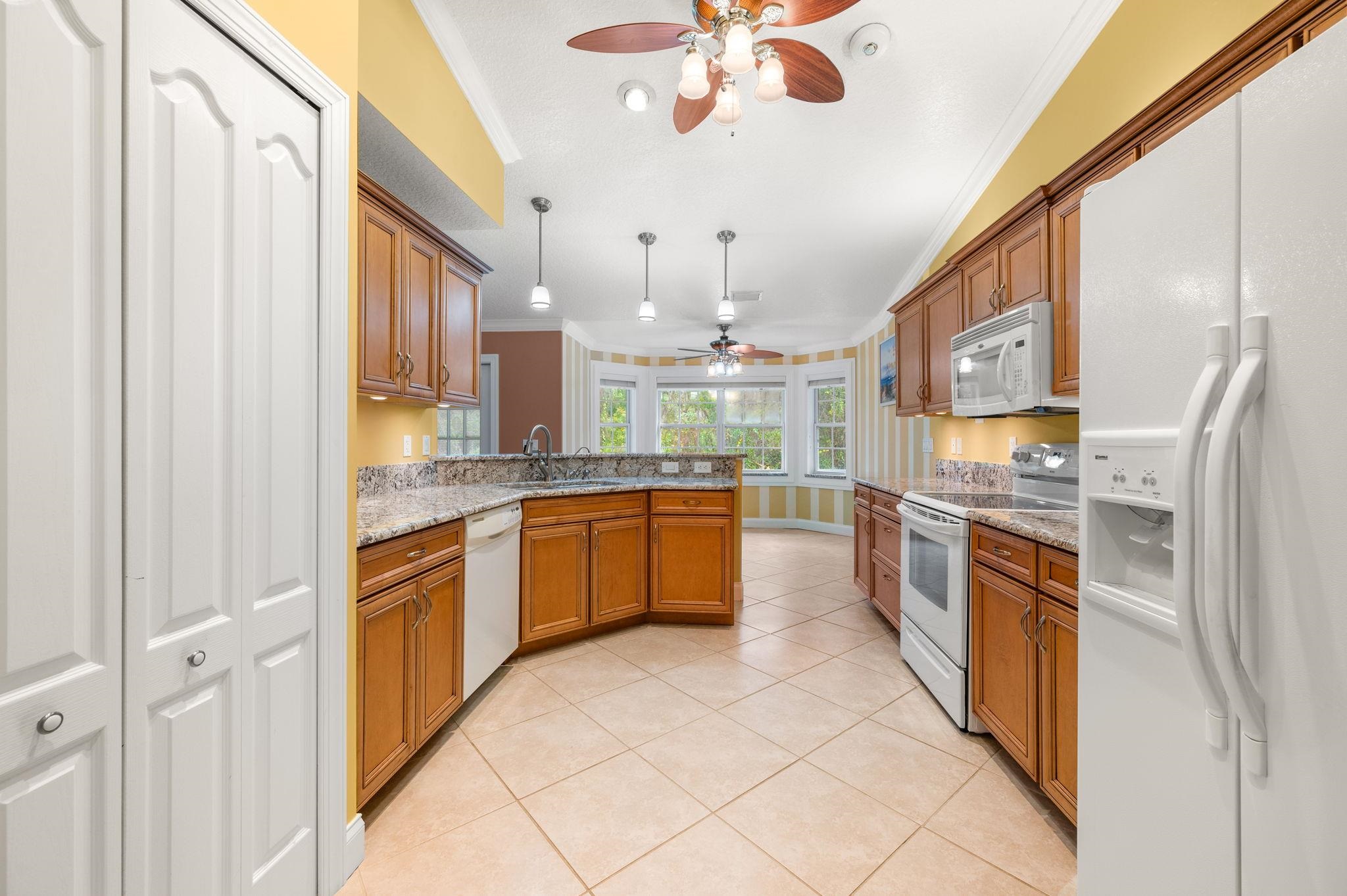 3489 Kings Road St. Augustine, FL 32086 - Photo 19 of 76 a large kitchen with stainless steel appliances granite countertop a refrigerator and a sink