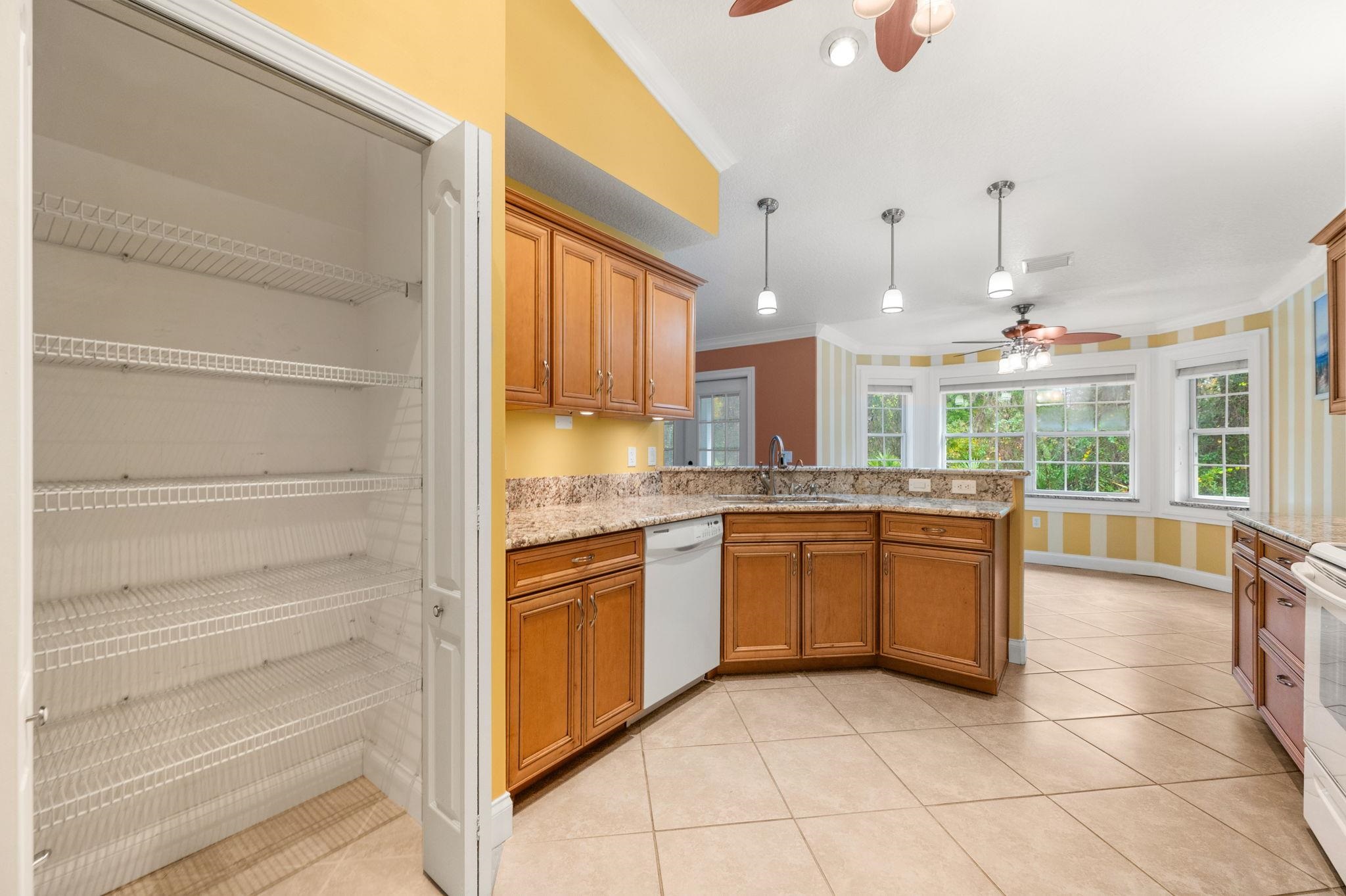 3489 Kings Road St. Augustine, FL 32086 - Photo 20 of 76 a kitchen with granite countertop a sink and cabinets